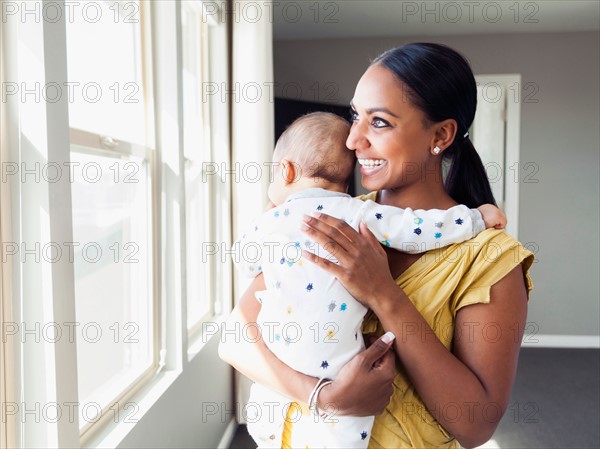 Woman holding her baby son (2-5 months)