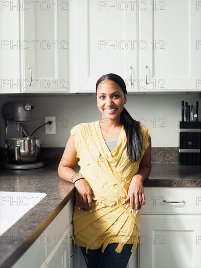 Portrait of woman standing in kitchen