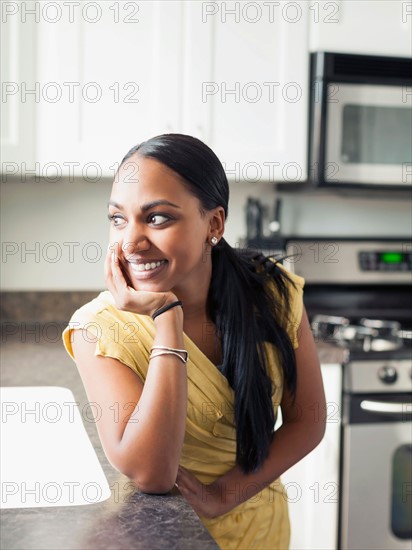 Portrait of woman standing in kitchen