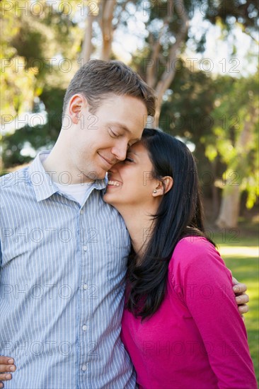 Couple embracing in park