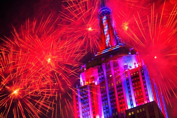 New York City, New York. Empire state building with firework display.