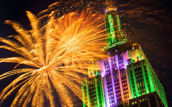 New York City, New York. Empire state building with firework display.