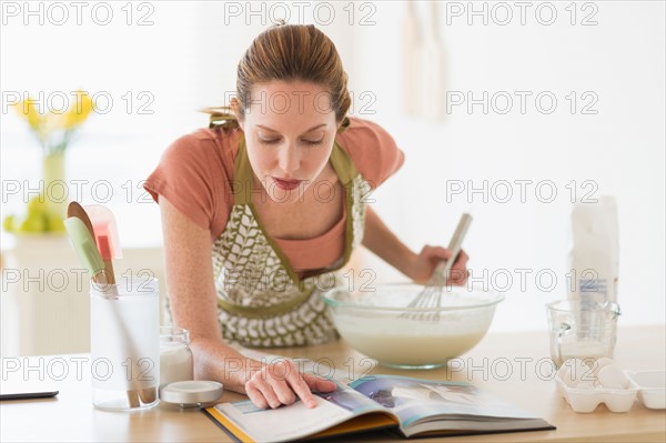 Woman cooking in kitchen.