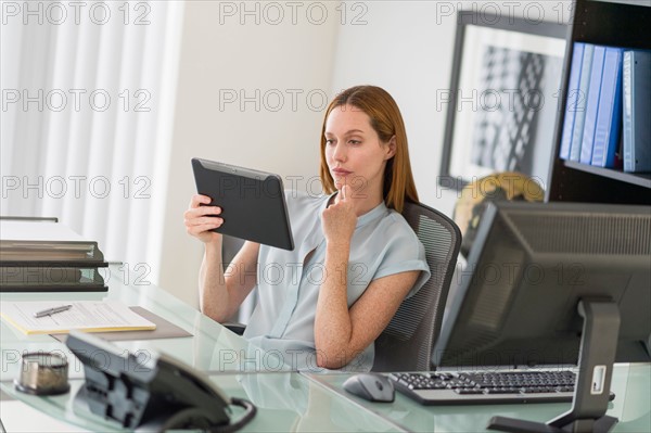 Business woman using tablet pc in office.