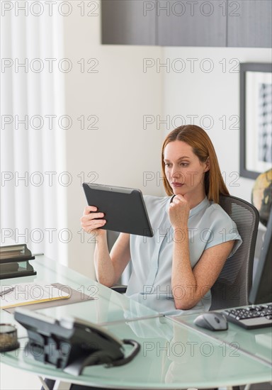 Business woman using tablet pc in office.