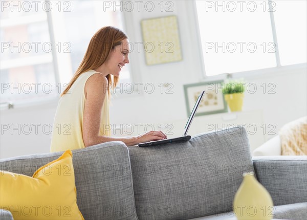 Woman using laptop at home.