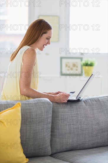Woman using laptop at home.