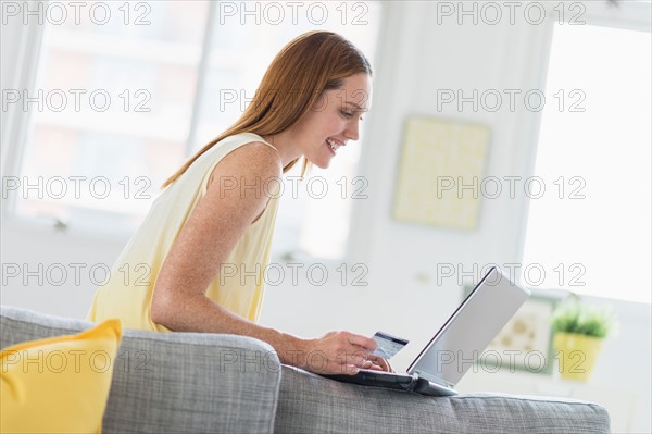 Woman using laptop at home.