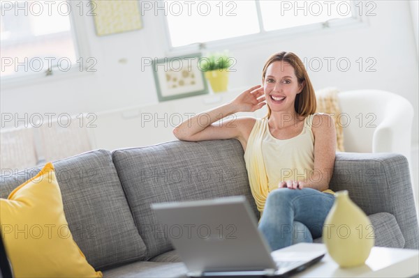 Woman using laptop at home.