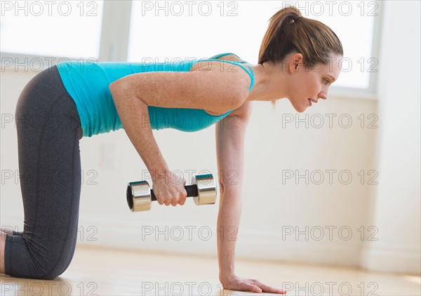 Woman exercising in gym.