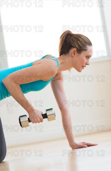 Woman exercising in gym.