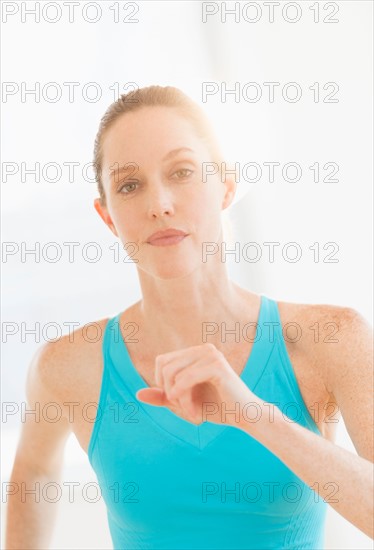 Studio portrait of woman exercising.