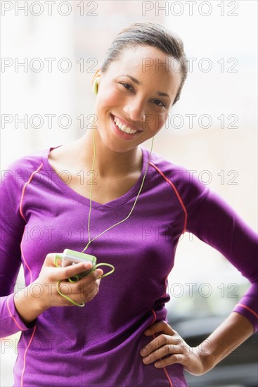 Portrait of female jogger with mp3 player.