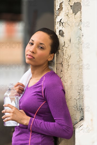 Portrait of female jogger with water bottle.