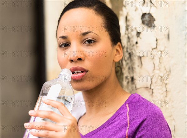 Portrait of female jogger with water bottle.