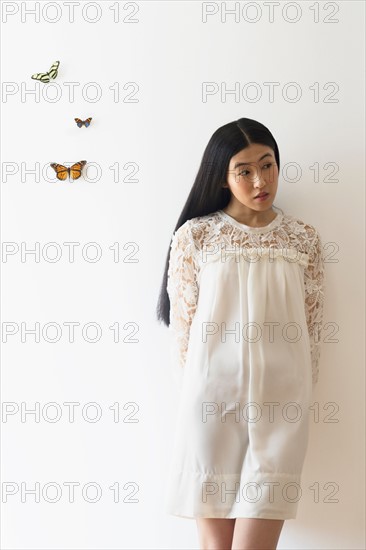 Studio shot of woman and butterflies.