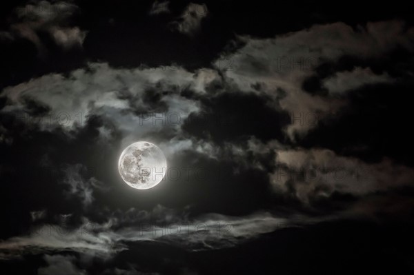 Dramatic sky with full moon.