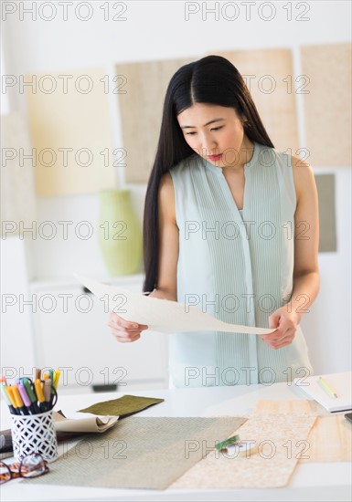 Business woman doing paperwork in office.