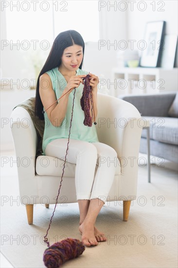 Woman knitting at home.