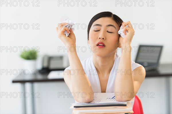 Businesswoman with stack of files.