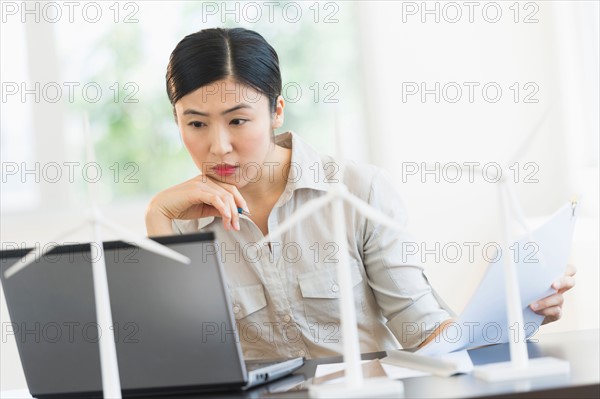 Female engineer working on laptop.