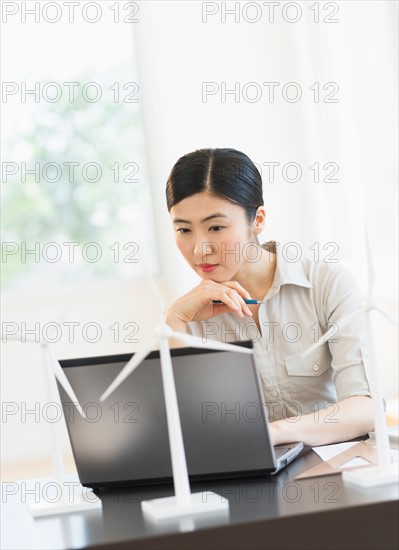 Female engineer working on laptop.