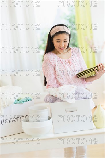 Woman donating household items.