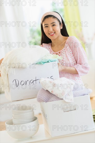 Woman donating household items.