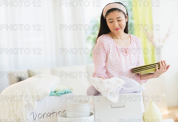 Woman donating household items.