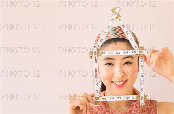 Woman holding tape measure .