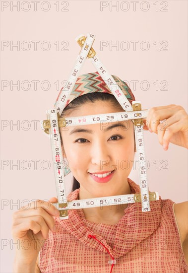 Woman holding tape measure .