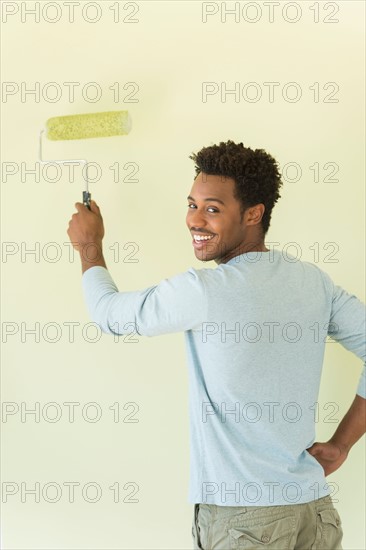 Man painting wall.