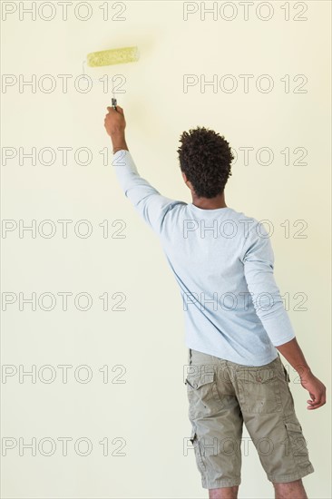 Man painting wall.