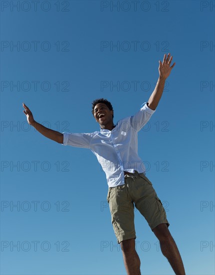 Happy man against clear sky.