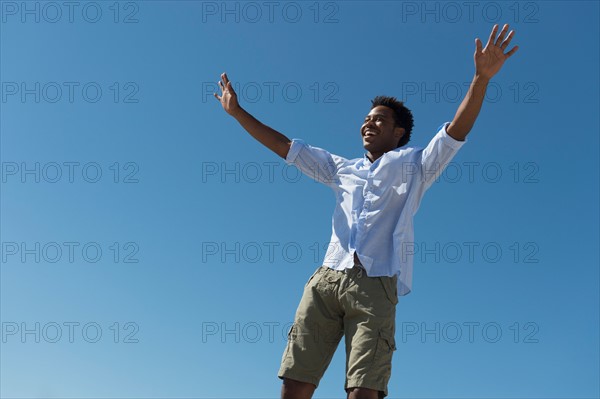 Happy man against clear sky.