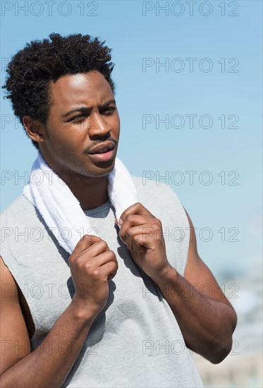 Athlete with towel on neck.