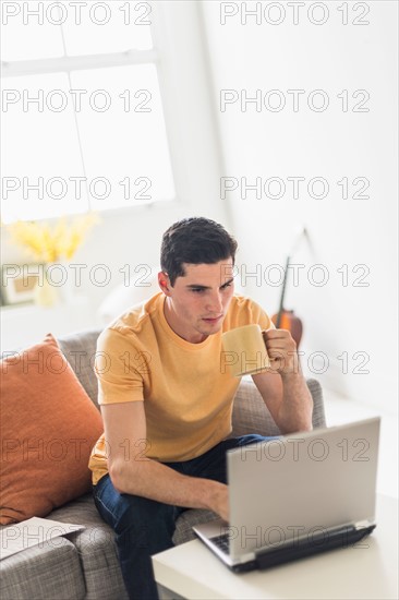 Man using laptop at home.