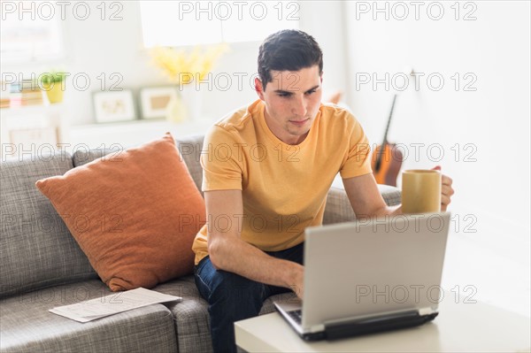 Man using laptop at home.