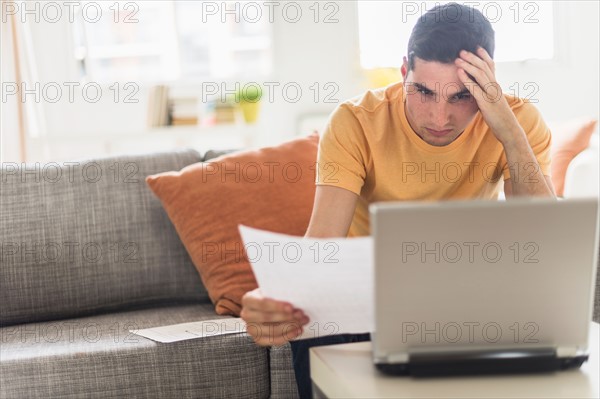 Man using laptop at home.