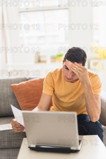 Man using laptop at home.