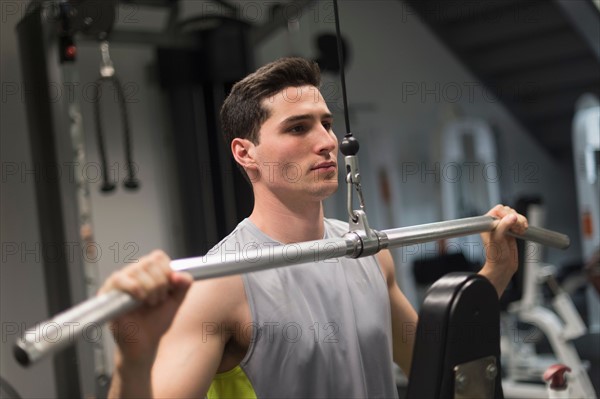 Man exercising in gym.