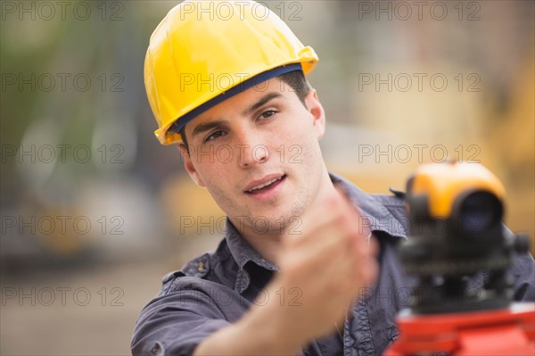 Engineer using theodolite.