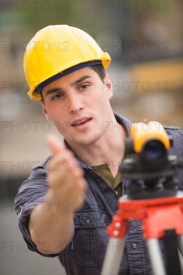 Engineer using theodolite.