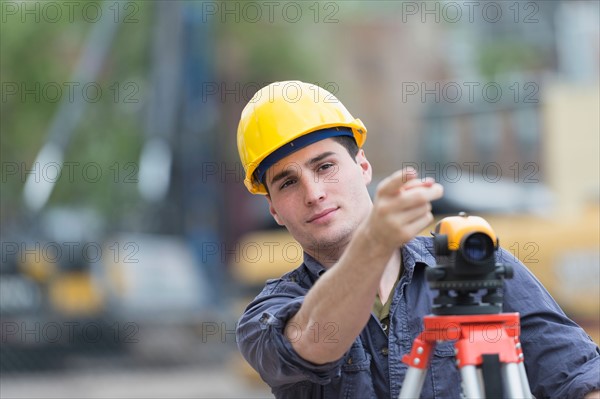 Engineer using theodolite.