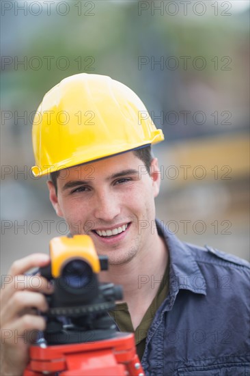 Engineer using theodolite.