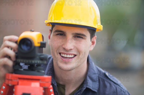 Engineer using theodolite.