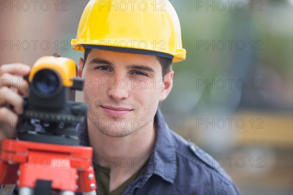 Engineer using theodolite.