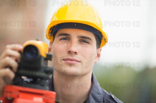 Engineer using theodolite.