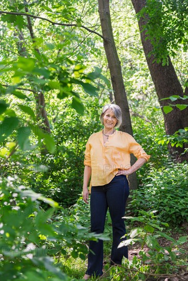 Central Park, New York City. Senior woman hiking in forest.