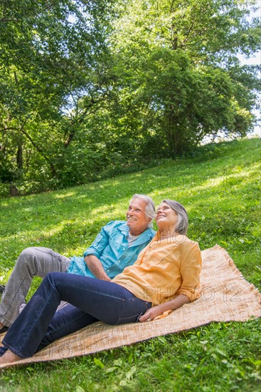 Central Park, New York City. Senior couple relaxing in park.